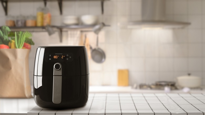 An air fryer on a kitchen table.