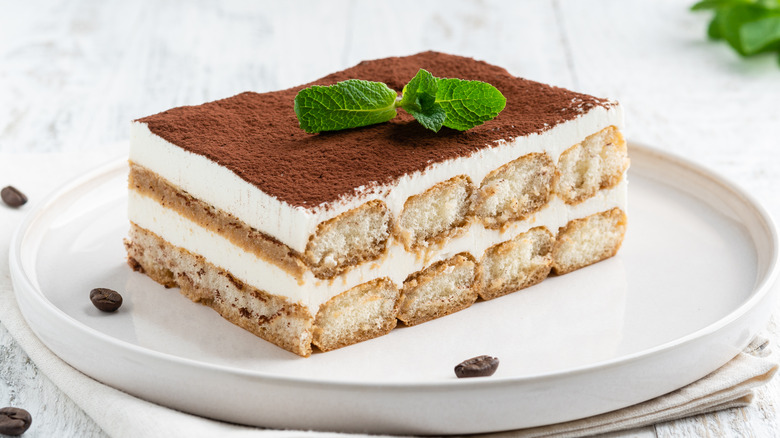 Slice of tiramisu on white plate