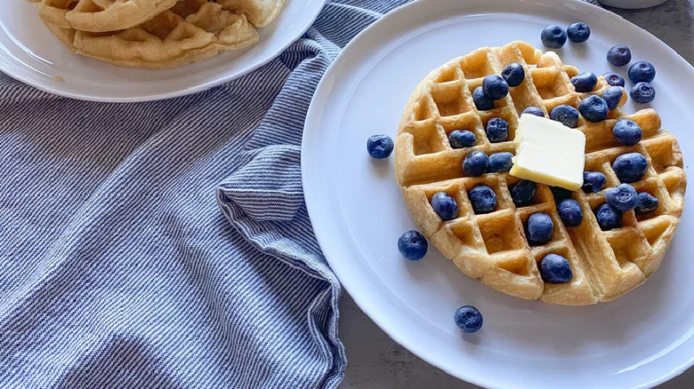 Belgian waffle with blueberries and butter