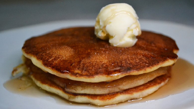 stack of pancakes with syrup and butter