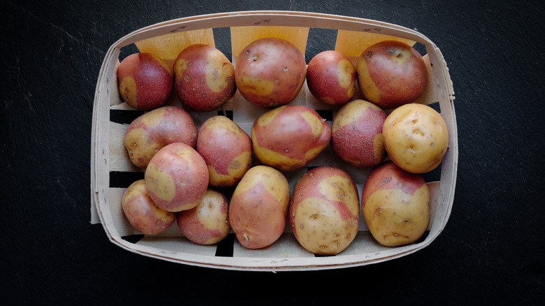 Masquerade potatoes in a basket on a black background