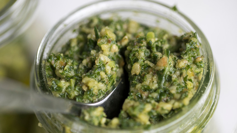 Spoon in jar of pesto