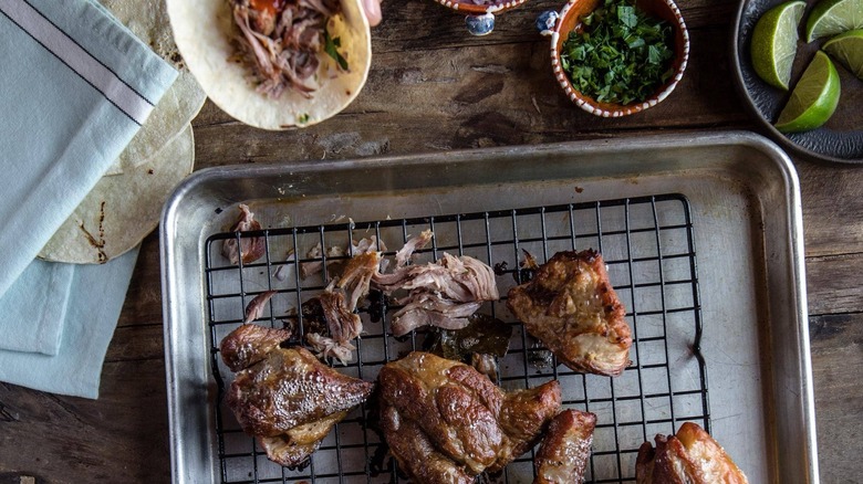 coke carnitas on rack on top of baking sheet