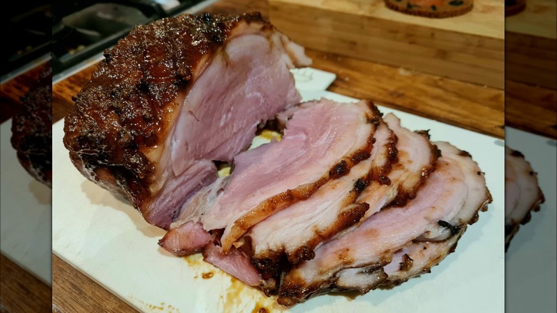 cola glazed ham slices against white plate