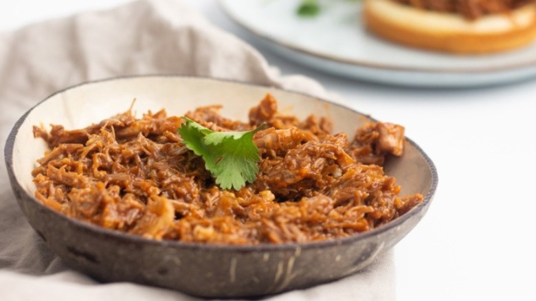 cola pulled pork in gray bowl on white surface