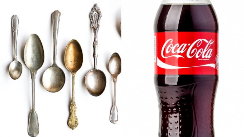 dirty silverware on left with bottle of coca-cola on right