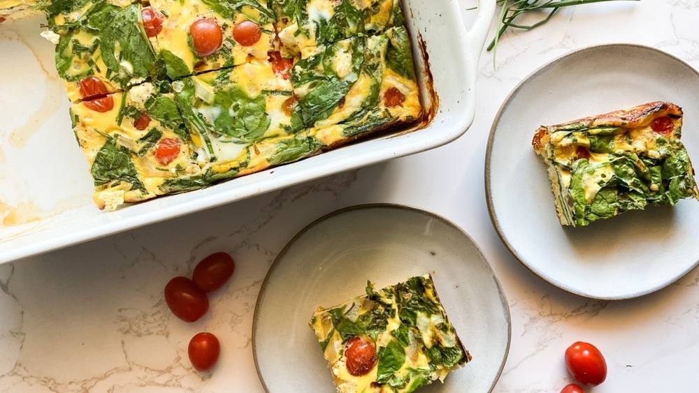 egg casserole in white baking dish and slices on white plates