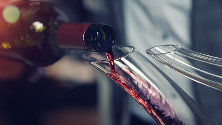 pouring wine into decanter