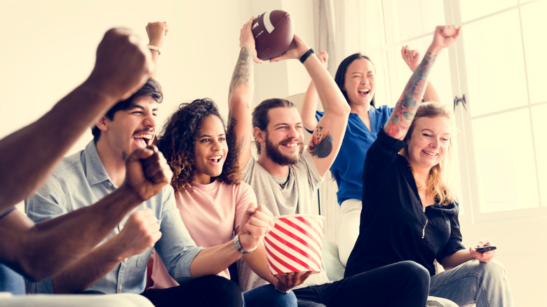 cheering football fans on couch