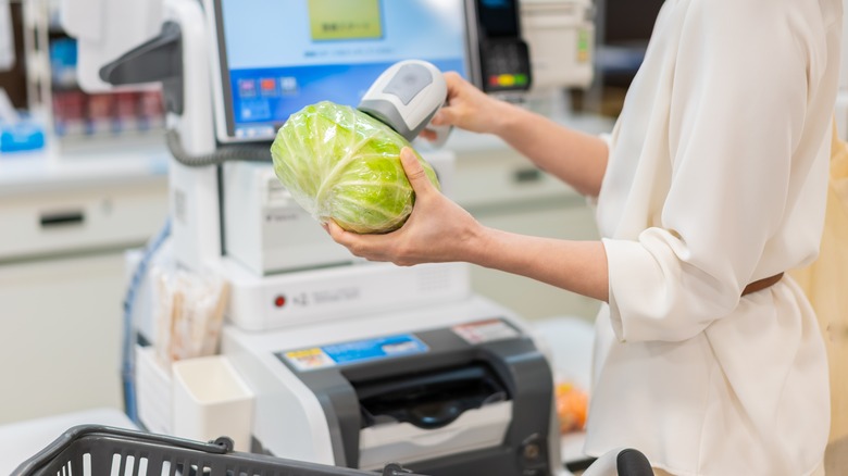 woman scanning cabbage