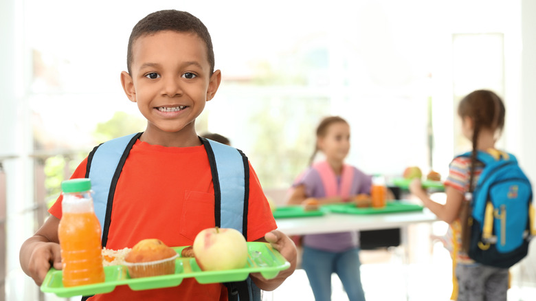 Child eating lunch off tray