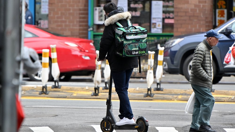 An Uber Eats delivery person on a scooter