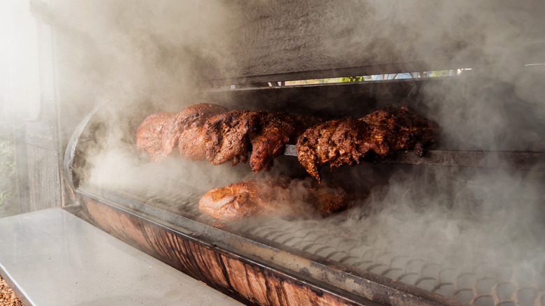 Barbecuing in a black smoker