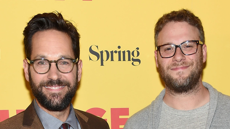 paul rudd and seth rogen smiling in glasses on the red carpet