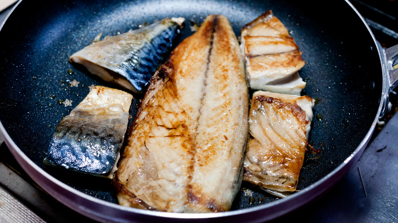 cooking fish in a pan