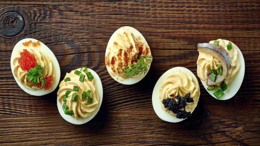 Deviled eggs with a variety of toppings