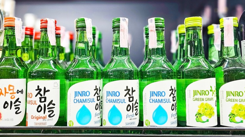 Green bottles of soju on a shelf