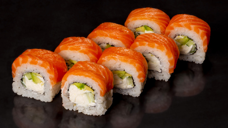 Sushi rolls against a black background