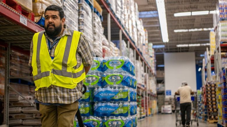 Warehouse worker pulling water pallet