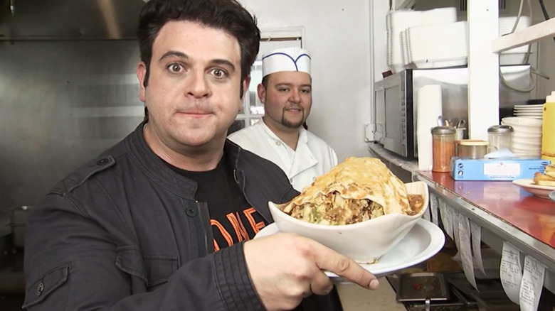 Adam Richman holding breakfast burrito