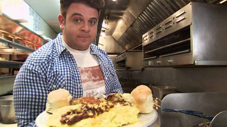 Adam Richman holding omelet plate