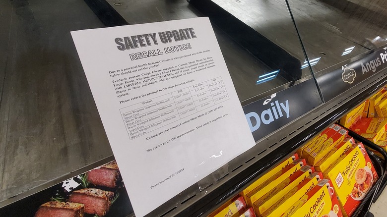 An empty deli counter at a grocery store with a recall notice posted on it