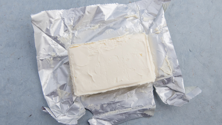 An unwrapped block of cream cheese shown from overhead