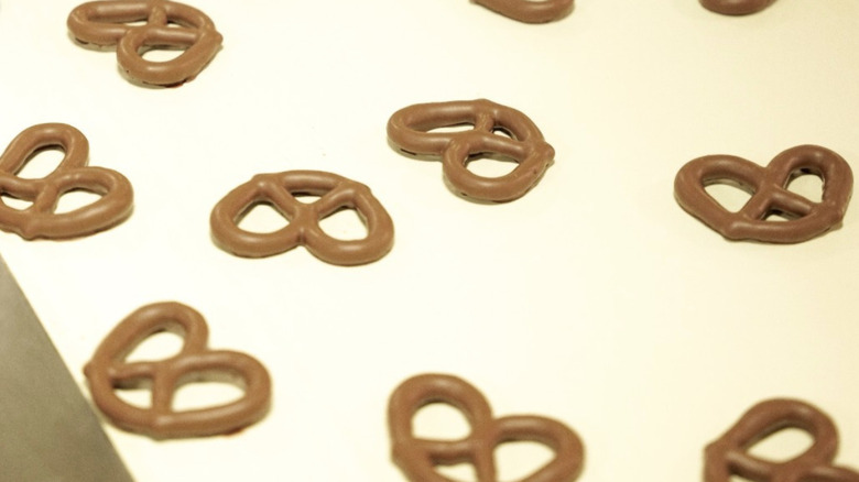 Chocolate-covered pretzels on factory assembly line