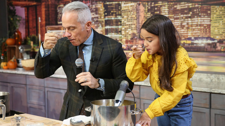 Geoffrey Zakarian tasting while cooking