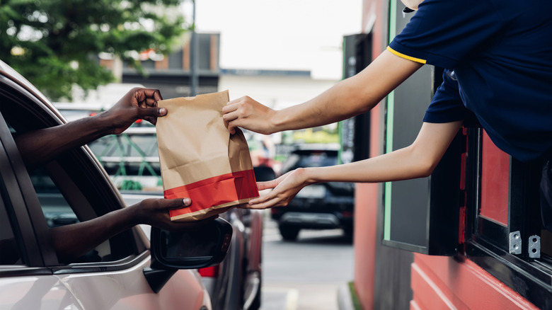 customer and worker at a fast food drive thru