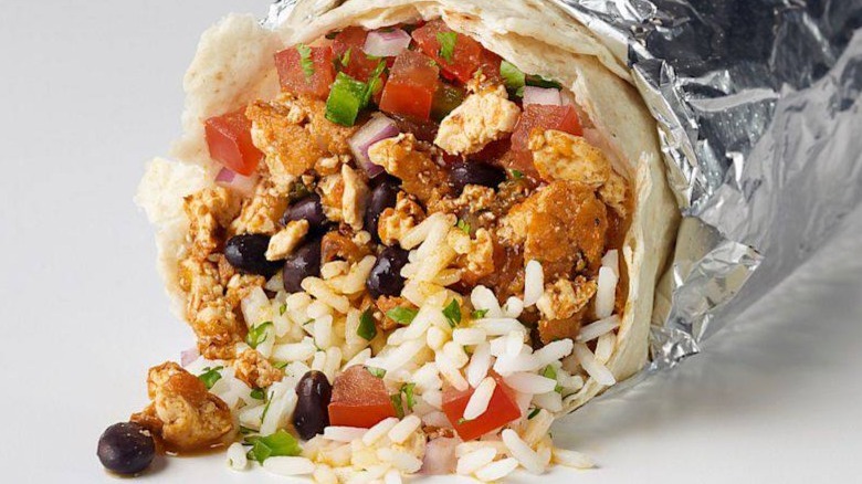 A chipotle burrito filled with rice, tomatoes, beans and sofritas