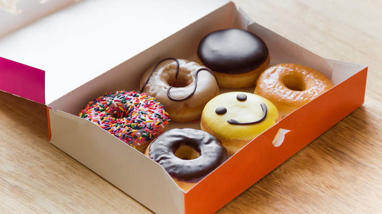 orange and pink box of donuts