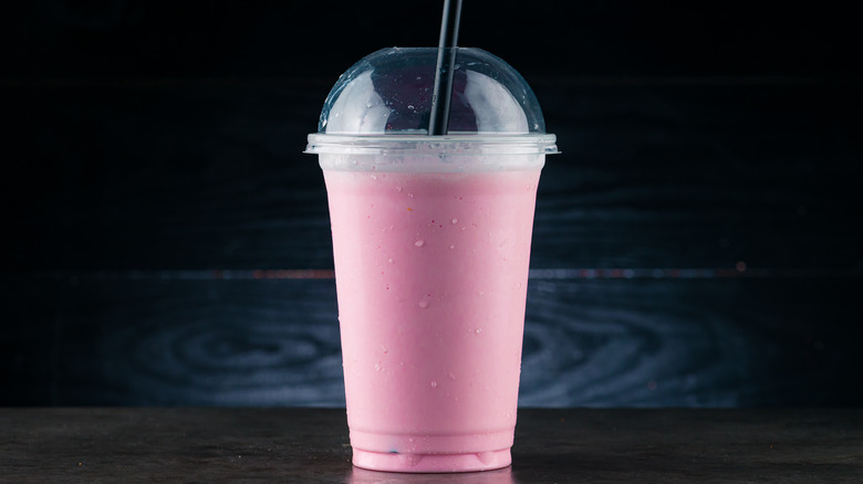 plastic cup with creamy pink drink