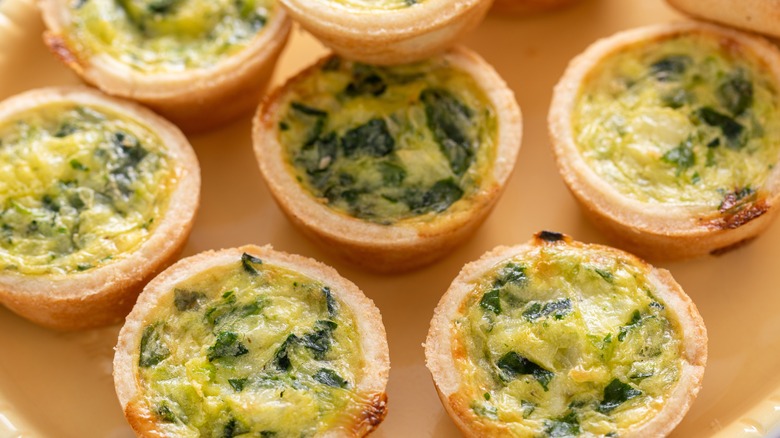 Closeup of mini quiches with spinach