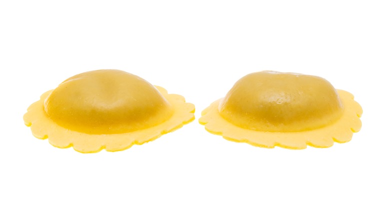 Two round raviolis on white background