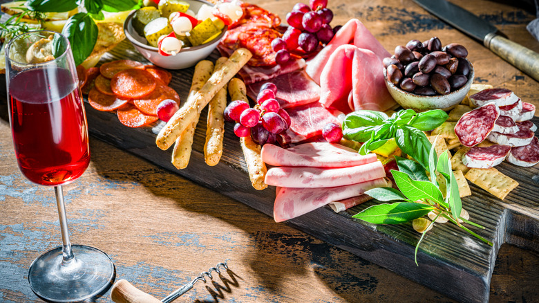 charcuterie board with glass of wine