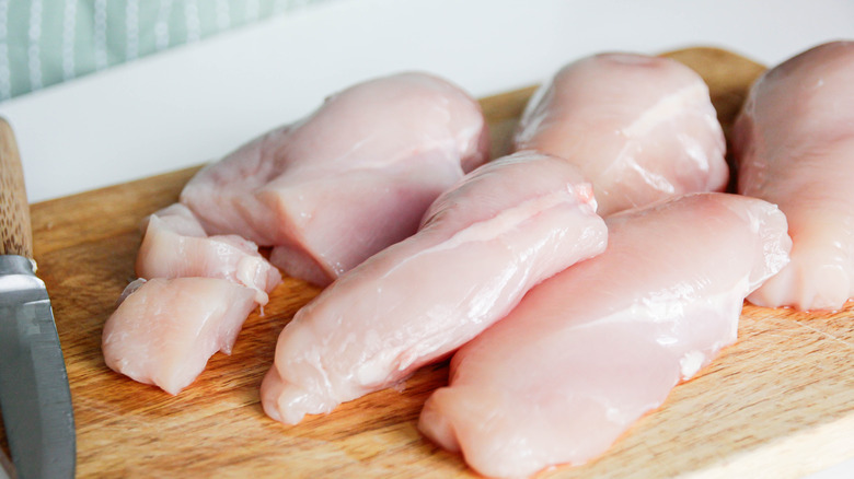 Raw chicken on cutting board