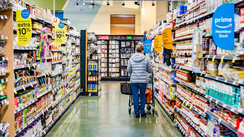 person shopping Whole Foods aisle