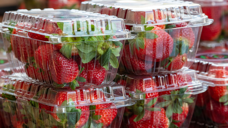 Fresh strawberries in clear plastic boxes