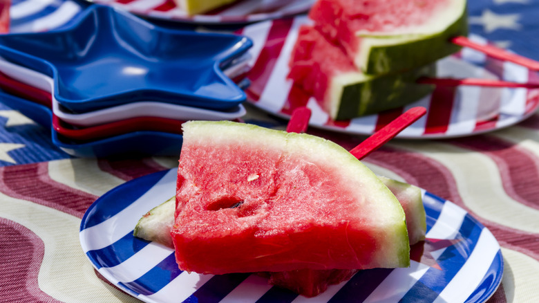 Sliced watermelon on July 4th-themed picnic table