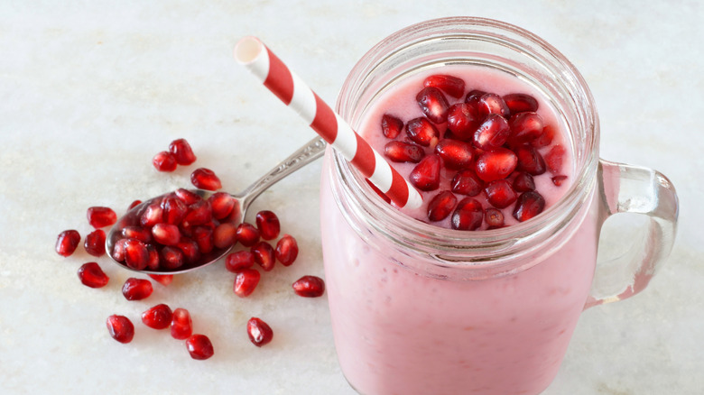 Pink smoothie topped with pomegranate seeds