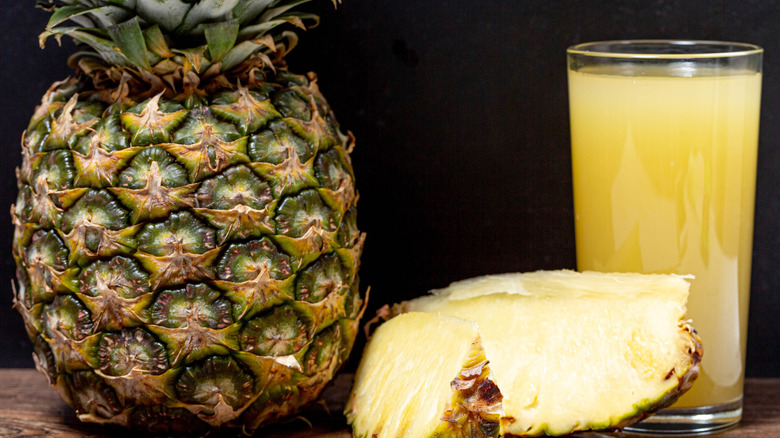 Glass of pineapple juice with fresh pineapple