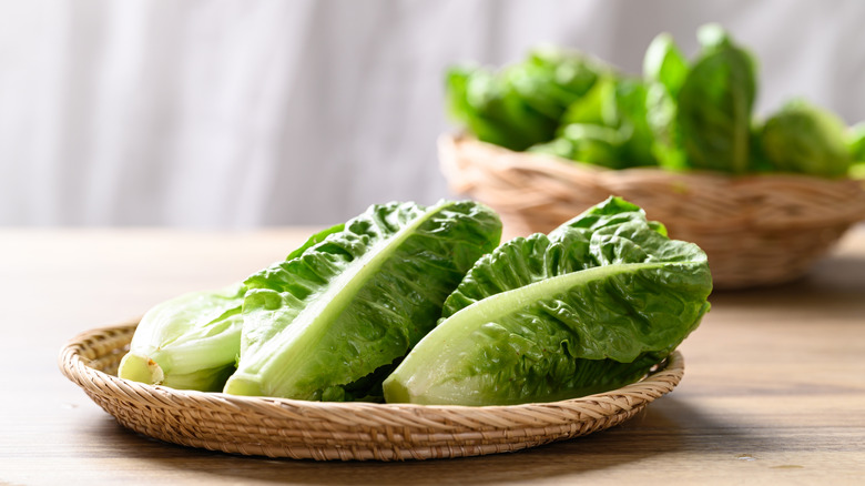 Baskets of romaine lettuce on wooden table