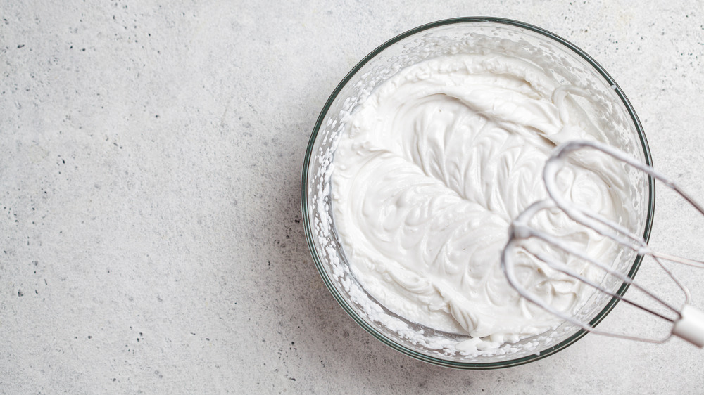 Bowl of whip cream with beaters