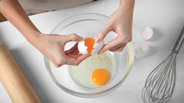 Cracking eggs into a bowl