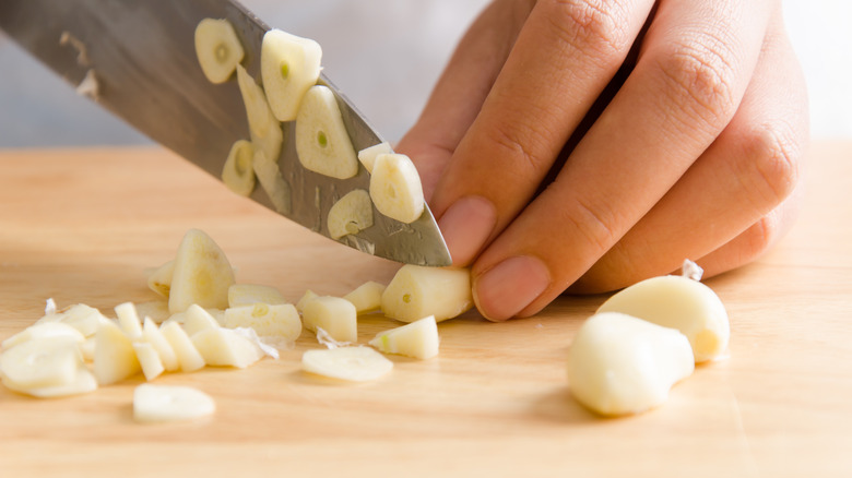 Chopping garlic with knife