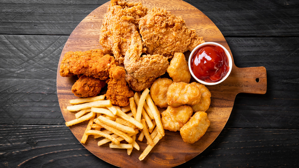fried chicken with french fries and chicken nuggets and ketchup