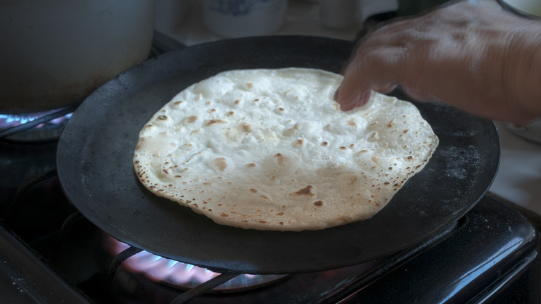 heating flour tortilla in pan