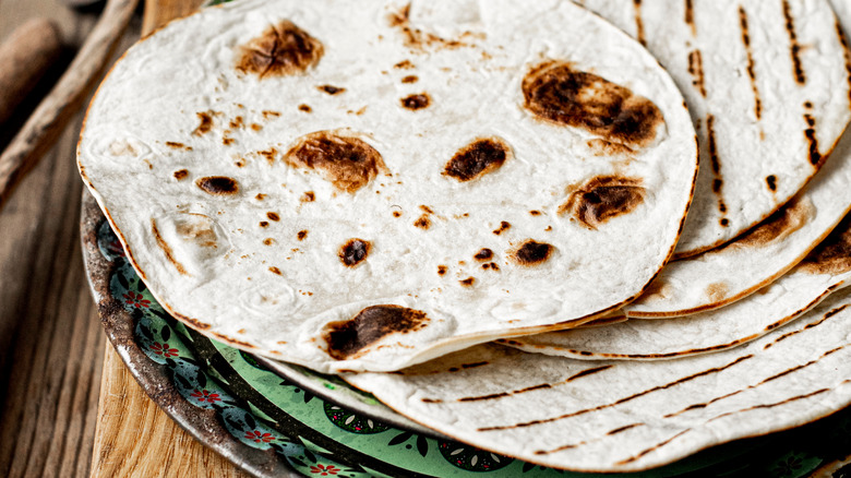 charred tortilla on green plate