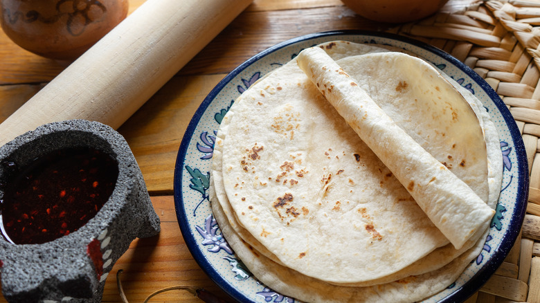 flour tortillas on blue and white plate 